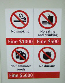 A sign, displayed on the MRT, warns that eating, drinking, flammable items, and smoking are prohibited as in common in subway systems. Durian fruit are banned on the system because of its odor. Some have used this as evidence of and accusing Singapore as being "fine city".